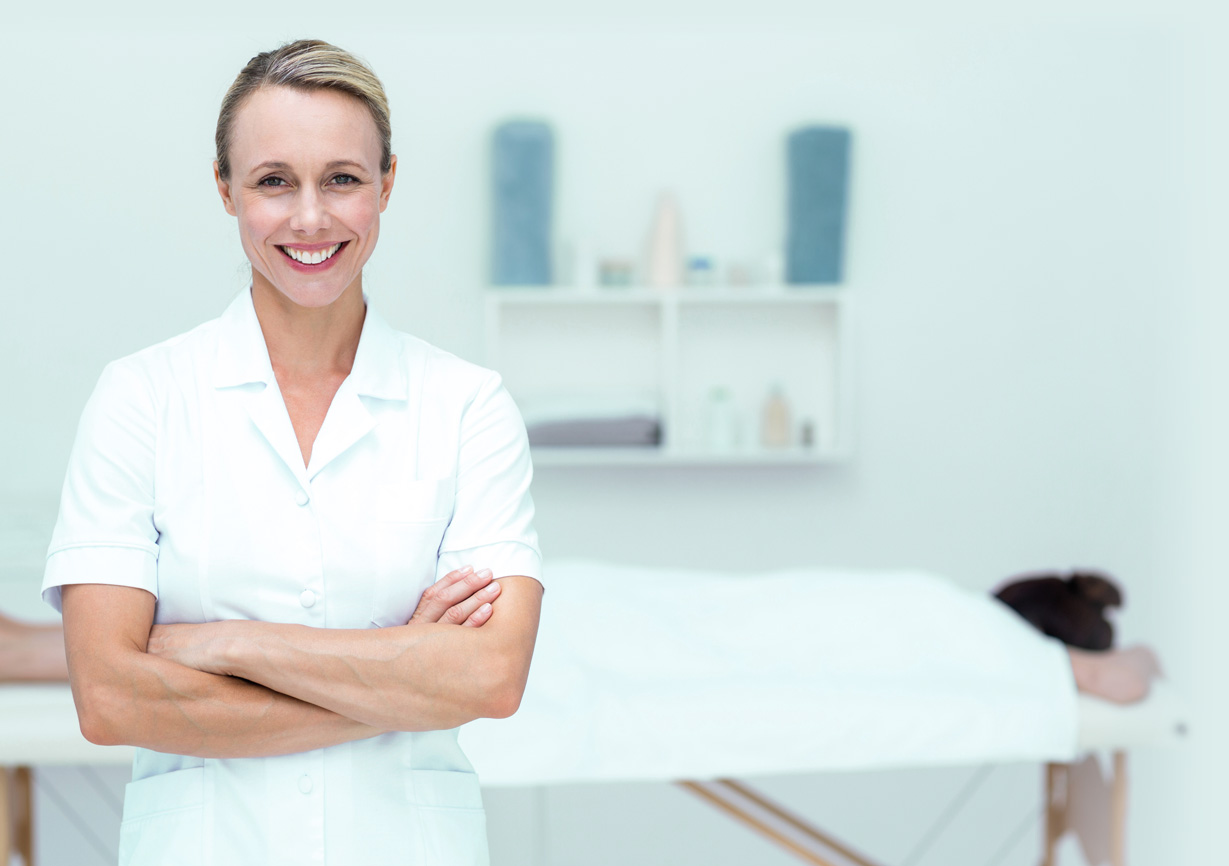 Physiotherapist smiling at camera arms crossed
